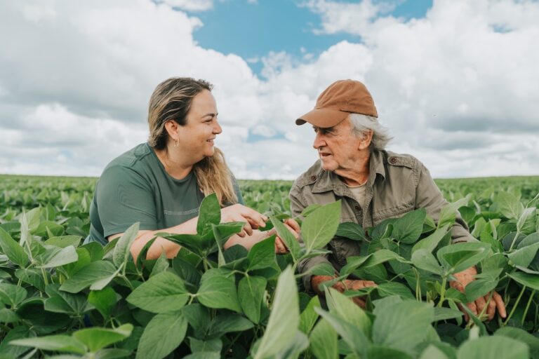 Female agronomist and farmer at soybean crop